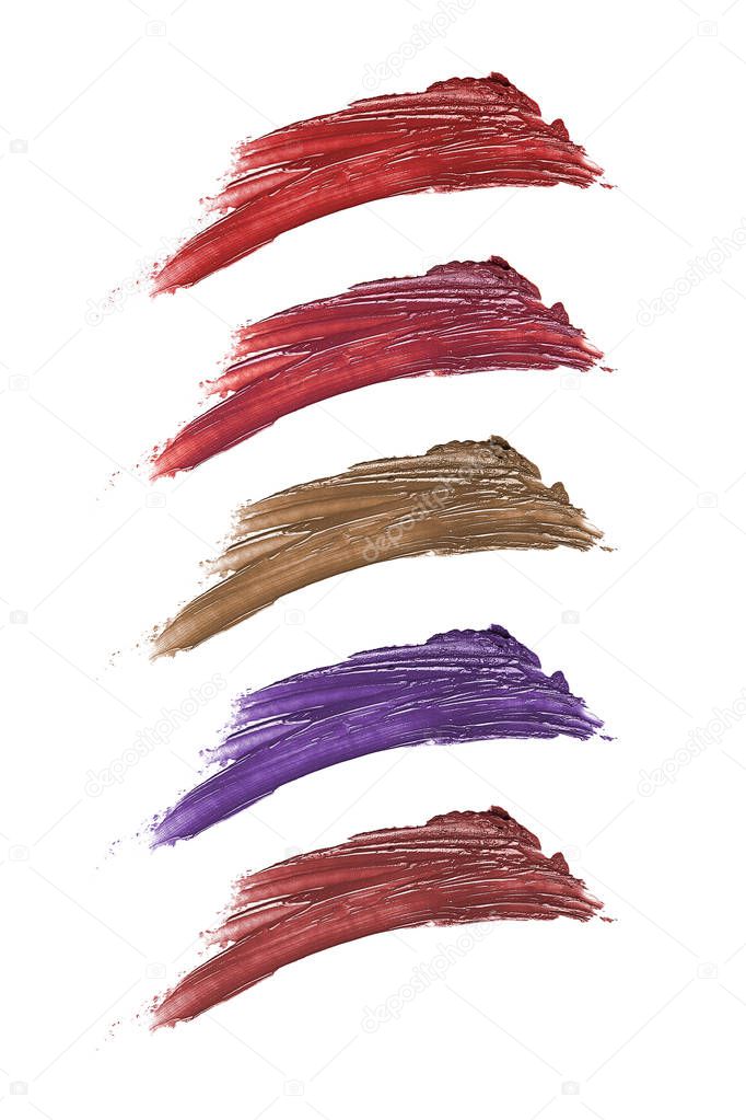 Multiple colors of lipstick or cosmetic smears on a white background. This fashion product  can also depict nail polish tones.  The product is swiped to show the texture close up. 