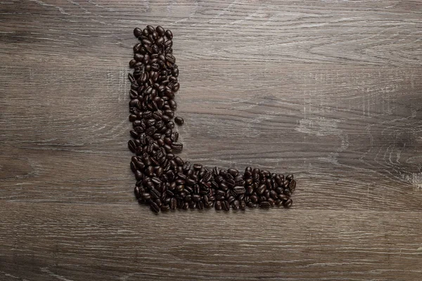 Grano Café Tostado Oscuro Dispuesto Una Mesa Madera Forma Letra — Foto de Stock