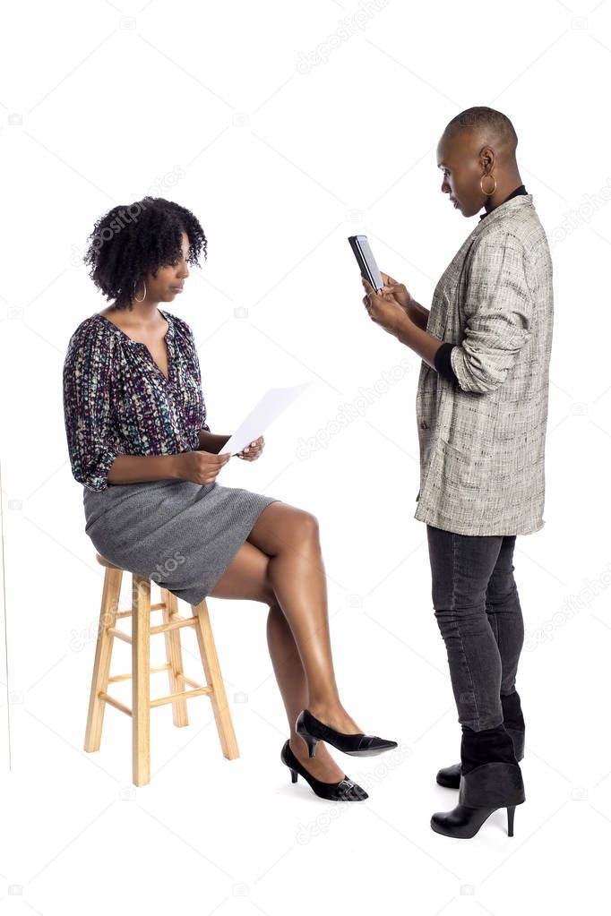 Black female actress doing a self tape audition via cell phone camera in a studio while reading to a casting director.  Depicts the Hollywood entertainment industry process.