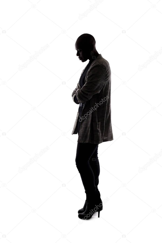 Black female African American model silhouette on a white background.  She is posed with a sad or depressed posture and hidden in shadow 