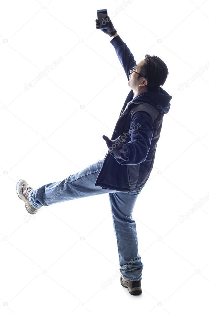 Male hiker or tourist doing a selfie and falling backwards.  Isolated on a white background for composites or copyspace. 