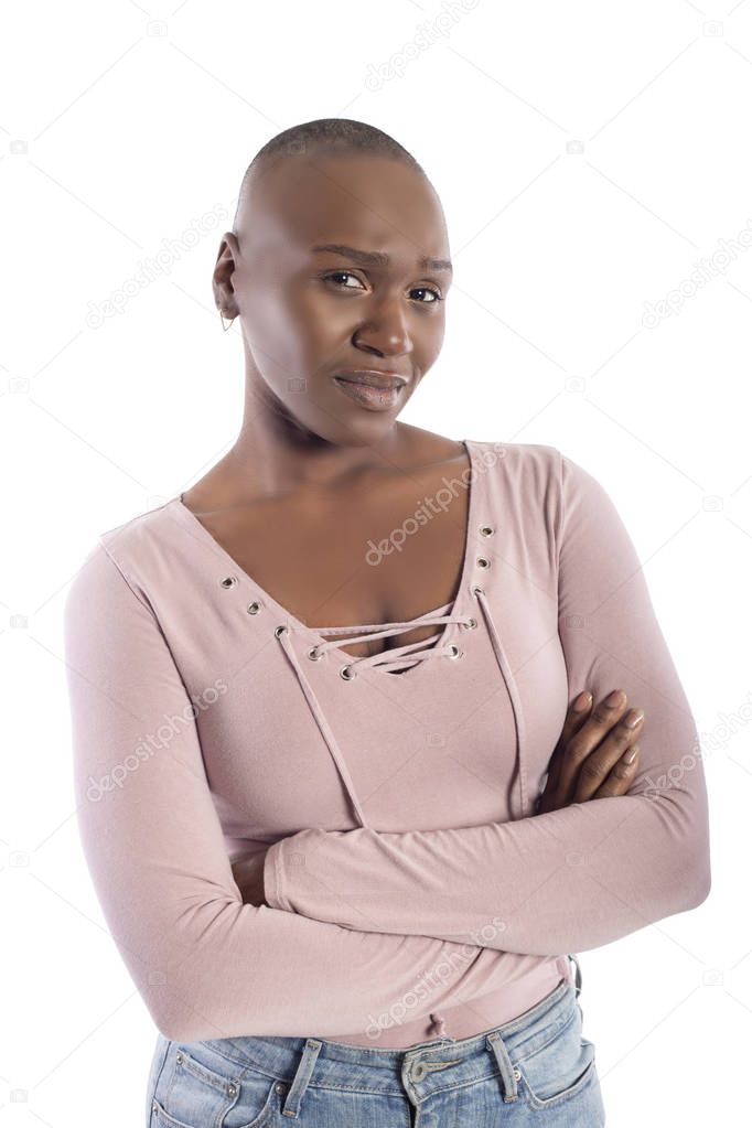 Black african american female model with bald hairstyle wearing a pink shirt on a white background looking skeptical and doubtful
