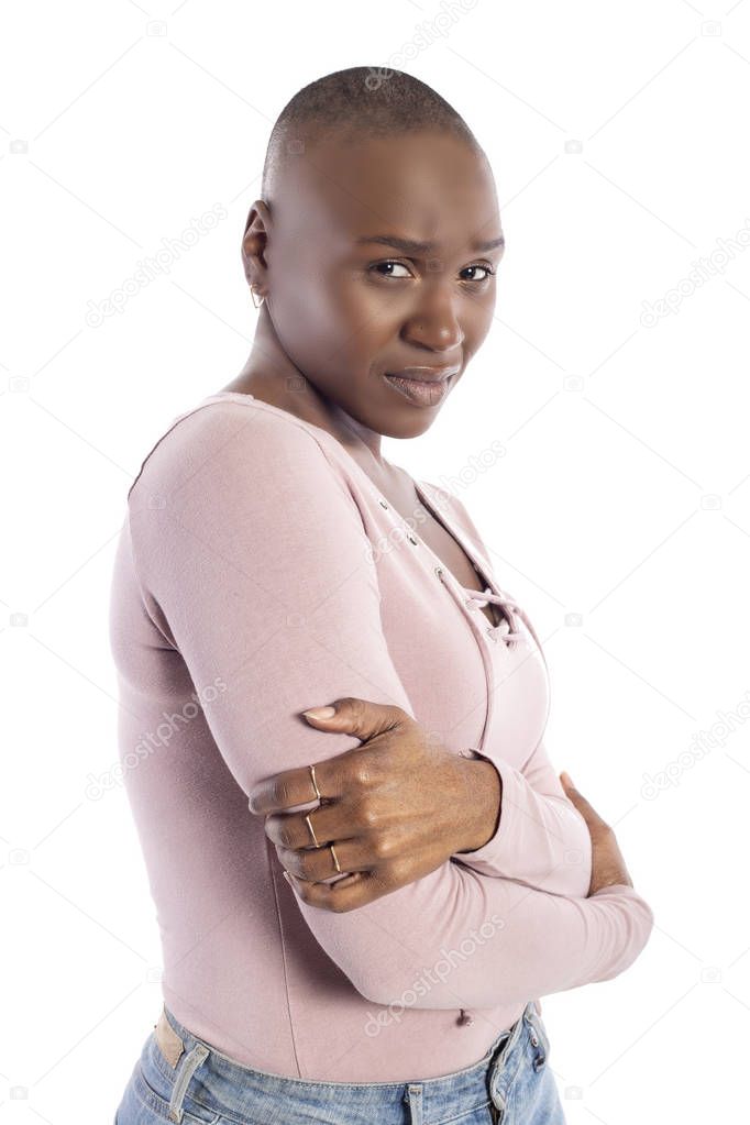Black african american female model with bald hairstyle wearing a pink shirt on a white background looking shy and embarrassed