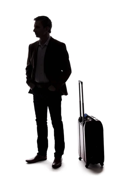 出差的商人的剪影 他提着行李等着 好像在机场出发或到达 复合材料在白色背景上隔离 — 图库照片