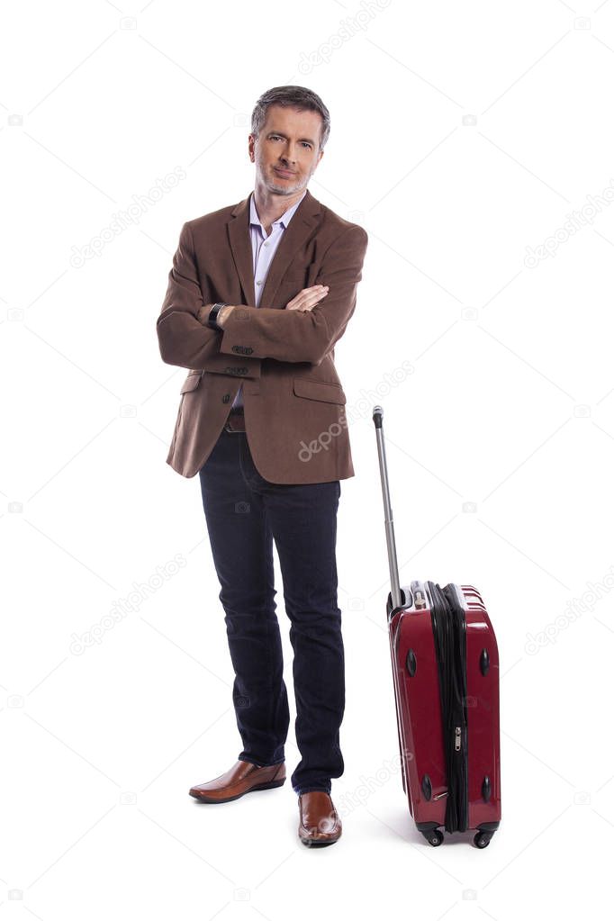 Businessman going on a business trip and traveling with luggage.  The man is carrying bags like preparing to board a flight at an airport. 