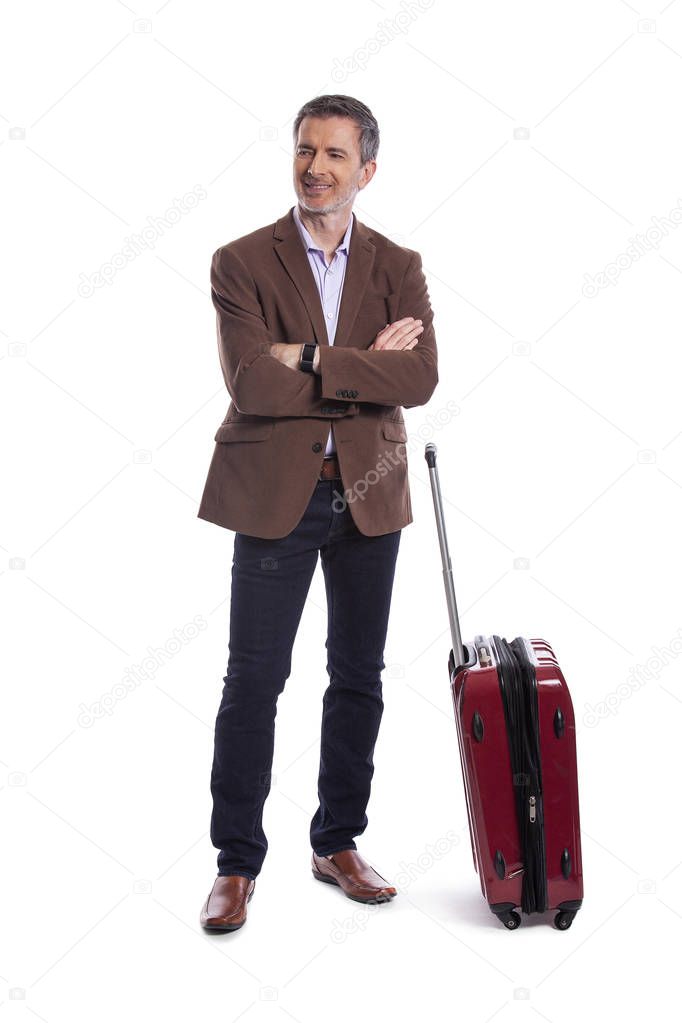 Traveling businessman going on a business trip.  He is waiting with luggage as if he is in the airport departure or arrival. Isolated on white background for composites. 