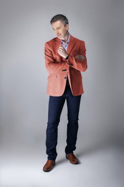 Sonbahar giyim koleksiyonu için mercan renkli spor ceket veya ceket giyen orta yaşlı moda modeli. 2019 için modern renkli giyim tarzı tasvir. 