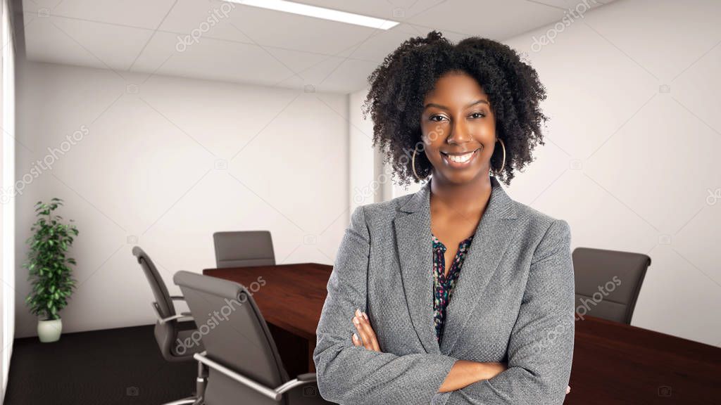 Black African American businesswoman in an office looking confident or arrogant.  She is an owner or an executive of the workplace.  Depicts careers and startup business. 
