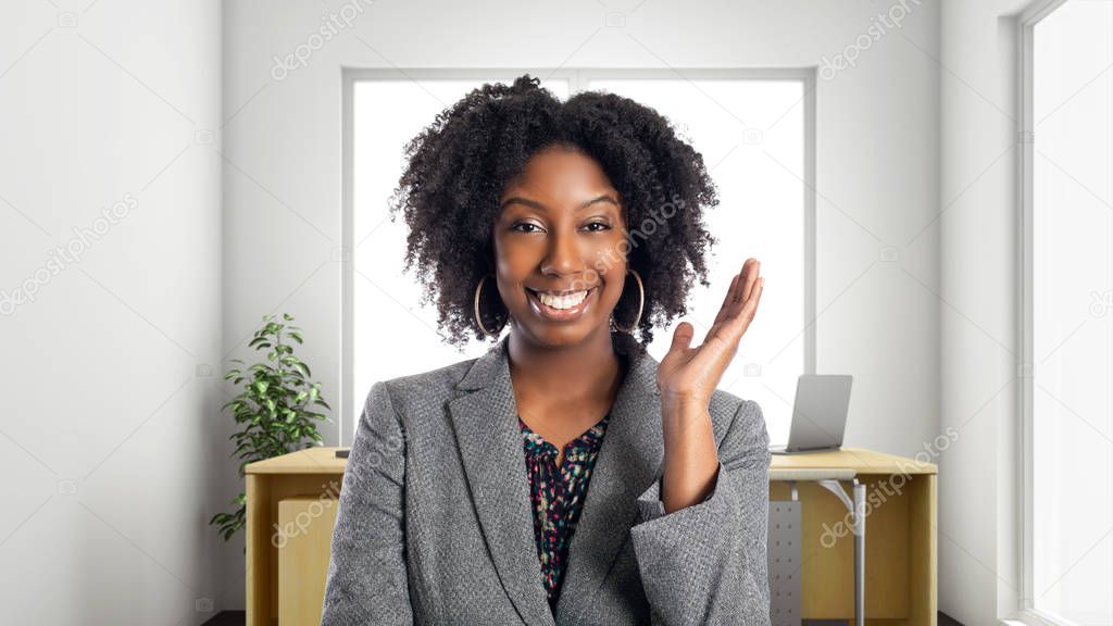 Black African American businesswoman in an office smiling happy.  She is an owner or an executive of the workplace.  Depicts careers and startup business. 