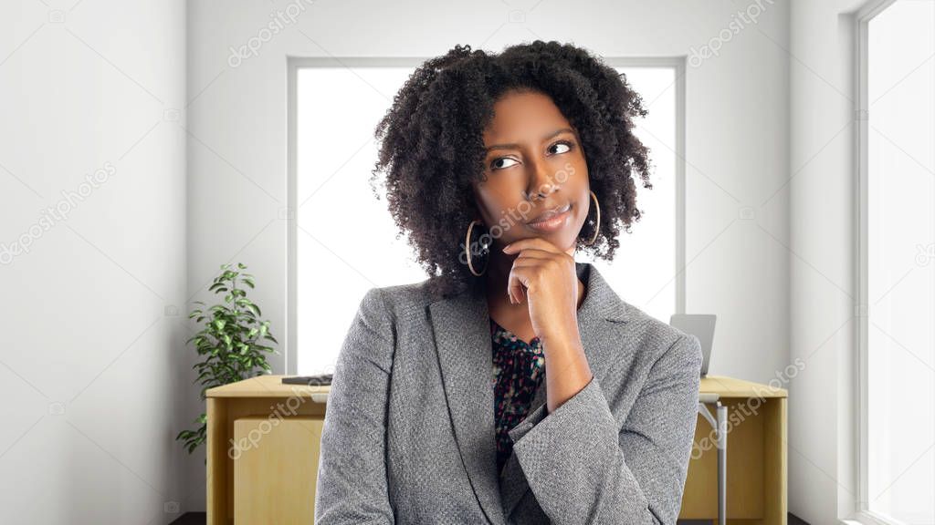 Black African American businesswoman in an office thinking of ideas.  She is an owner or an executive of the workplace.  Depicts careers and startup business. 