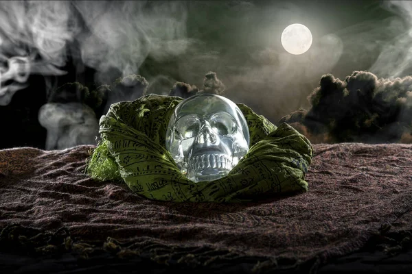 Scary or creepy glowing crystal skull on Halloween holiday or Dia De Los Muertos Day of the Dead festival.  Depicts horror theme and superstition.