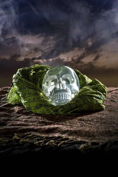 Scary or creepy glowing crystal skull on Halloween holiday or Dia De Los Muertos Day of the Dead festival.  Depicts horror theme and superstition.