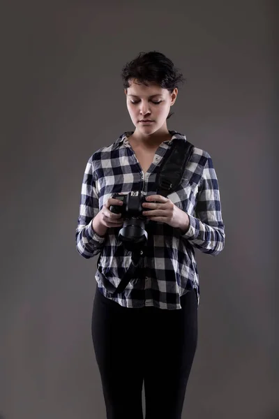 Young Female Photographer Holding Camera Studio She Posed Lit Background — Stock Photo, Image