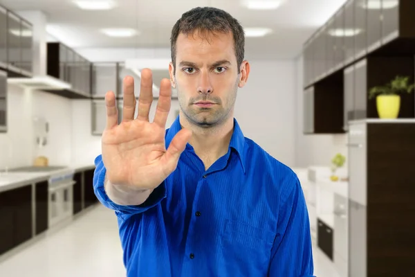 Small business owner with a restaurant or kitchen looking worried of covid shutdown and holding hands up as a stop gesture in response to rules and policies or customers.