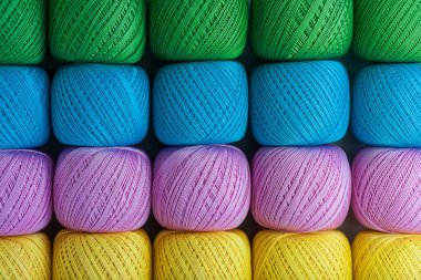 A stack of tangles of thick cato of different colors for knitting.