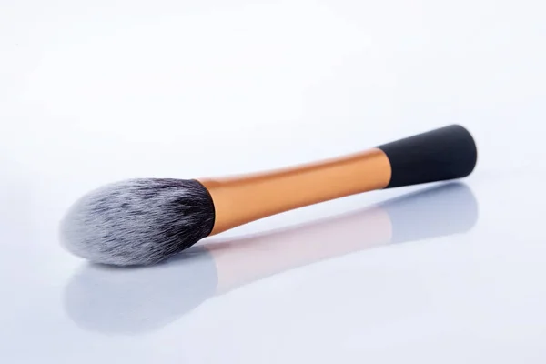 Thick makeup brush with gold handle and soft boost. Brush for makeup on a white background — ストック写真