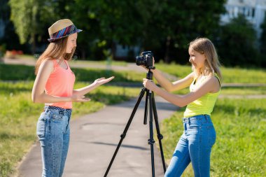 Kızlar kız için. Doğa yazın. Onlar rahat kıyafetler giymiş. Bir konuşma yapmak. Kayıt vlog ve blog abone. Internet için kayıt video ders. Kullanma fotoğraf makinesi tripod ile.