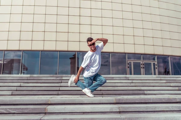 şehirde yaz aylarında dansçı, dans break dans, alt stil, boş alan, kot t-shirt spor ayakkabı, güneş gözlüğü, atlama aktif hareket