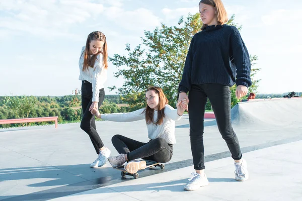 3 Freundinnen fahren Skateboard Schulmädchen Teenager Mädchen, herbstliche warme Pullover haben Spaß, glücklich Spaß haben, spielen, nach der Schule entspannen, Emotionen der Freude und Freude am Vergnügen. im Sommer Stadtnatur — Stockfoto