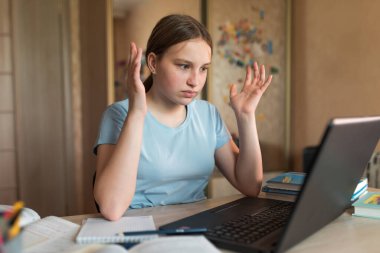 Teenager girl, surprised upset, misunderstanding embarrassment and indignation, home lessons with laptop, video training on Internet. Bad rating and internet error. Bad exam and social media conflict.