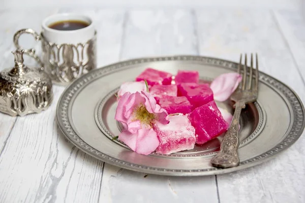 traditional bulgarian rose lokum on a silver plate and turkish coffee