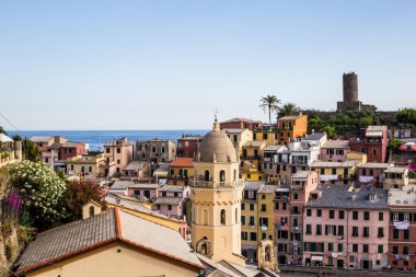 Vernazza, İtalya - 8 Temmuz 2017: Arka planda Doria Kalesi ve Ligurian Denizi ile birlikte Santa Margherita di Antiochia Kilisesi ve Renkli Evler