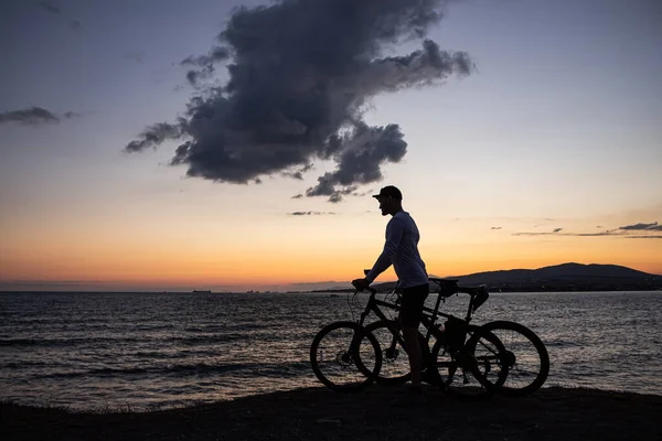 Gün Batımında Bisikletle Uçurumun Kenarında Duran Bir Adamın Silueti Güzel — Stok fotoğraf