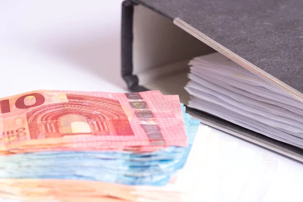 Euro bills and a folder with documents