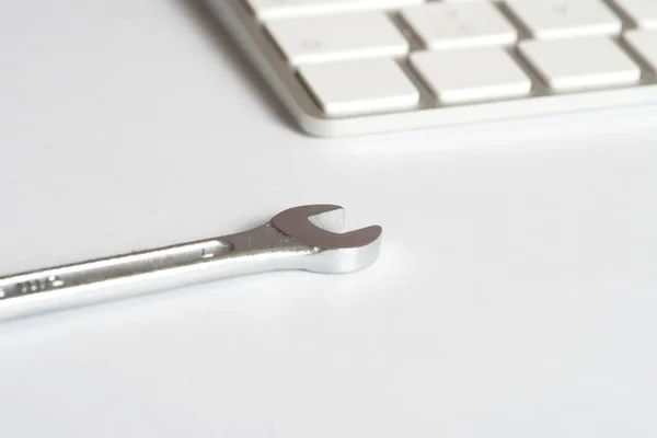 An open-end wrench and repair service for a computer