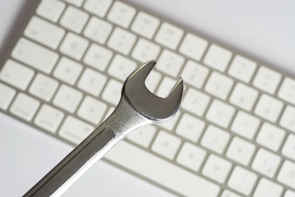 An open-end wrench and repair service for a computer