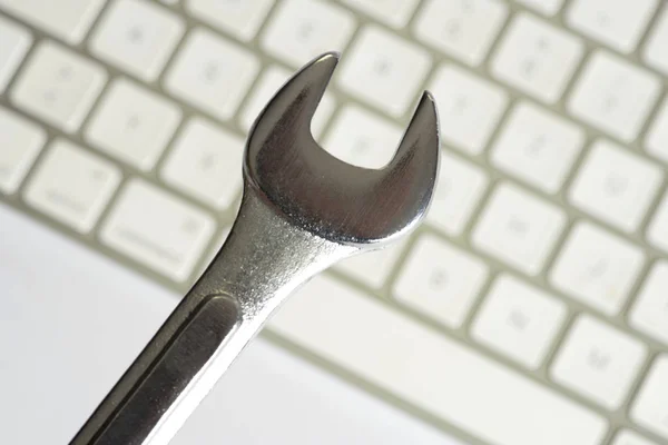 An open-end wrench and repair service for a computer