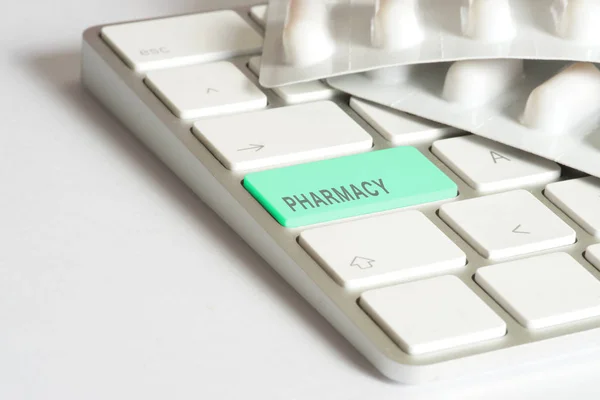 Tablets and a computer with the key for Online Pharmacy