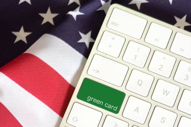 American flag, computer keyboard and the key with the imprint Green Card clipart