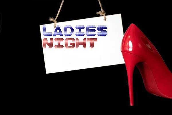 A red high heel and a sign with the imprint Ladies Night