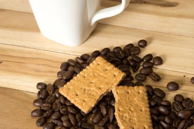 Kahve çekirdekleri, bisküvi ve bir fincan kahve