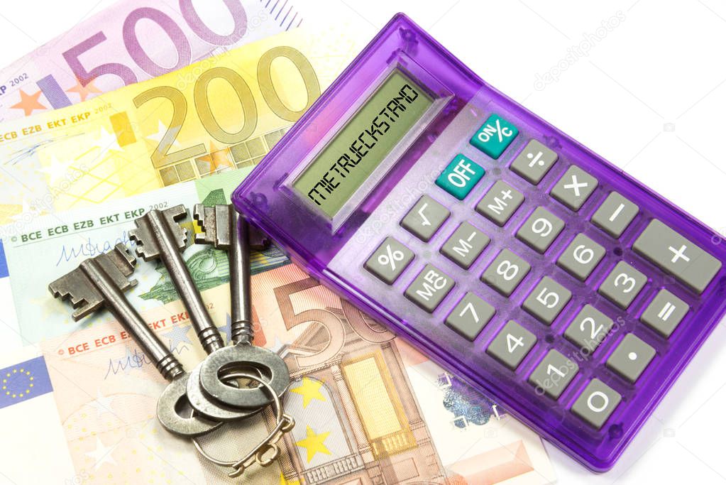 Euro banknotes, house keys and a calculator for rent arrears