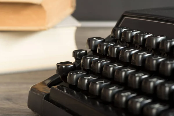 A typewriter and books