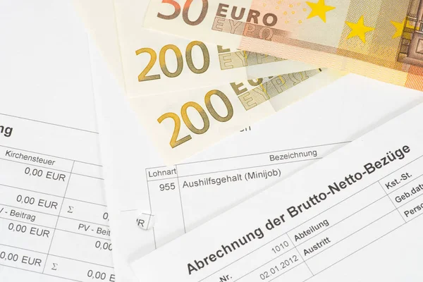 A pay slip and euro bills