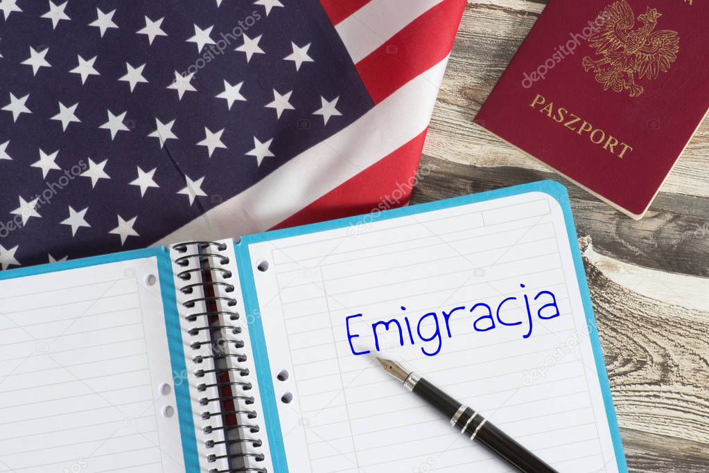 A Polish passport, flag of USA and the Polish word for emigration