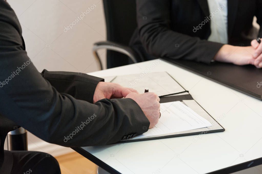 A man signs a contract of employment