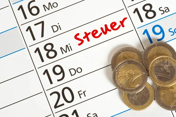 A calendar with the reminder of tax payment and euro coins