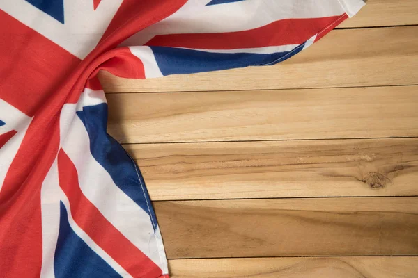 The flag of Great Britain on a wood background
