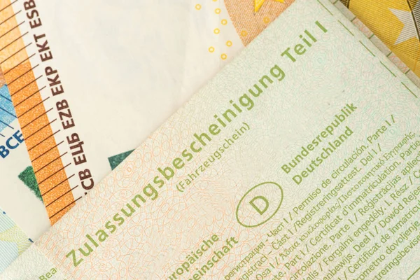 A vehicle registration for a diesel car and euro bills