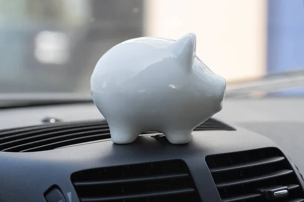 A piggy bank and interior of a car