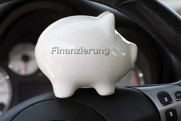 A piggy bank with the imprint Financing and the interior of a cart