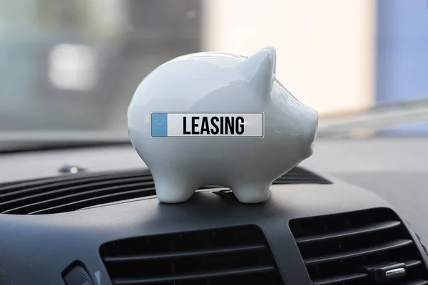 Interior of a car, piggy bank and leasing