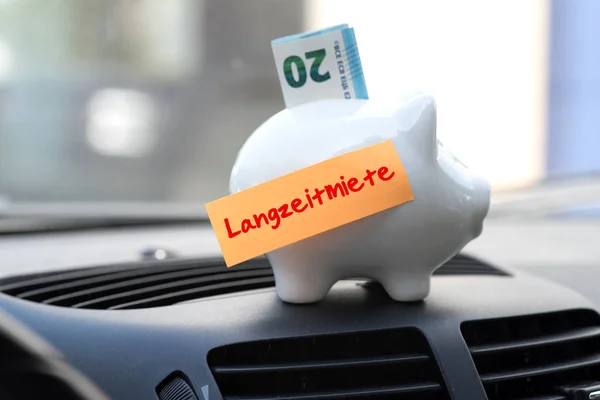 Interior of a car, piggy bank and the long-term rental