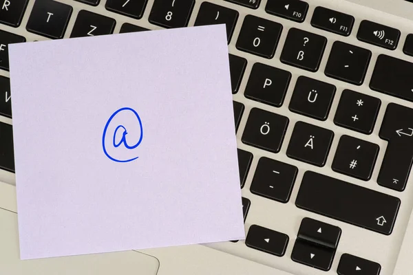 A computer and AT sign as a symbol for an e-mail