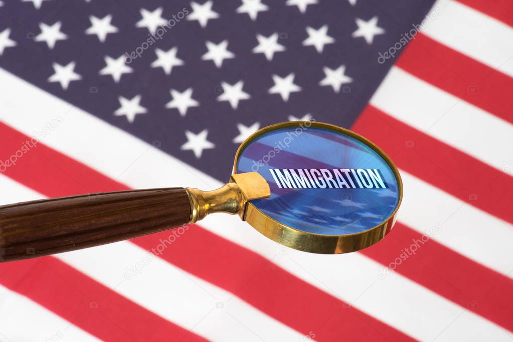 Flag of the USA, a magnifying glass and the immigration to America