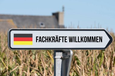 A sign, german flag and slogan skilled workers welcome clipart
